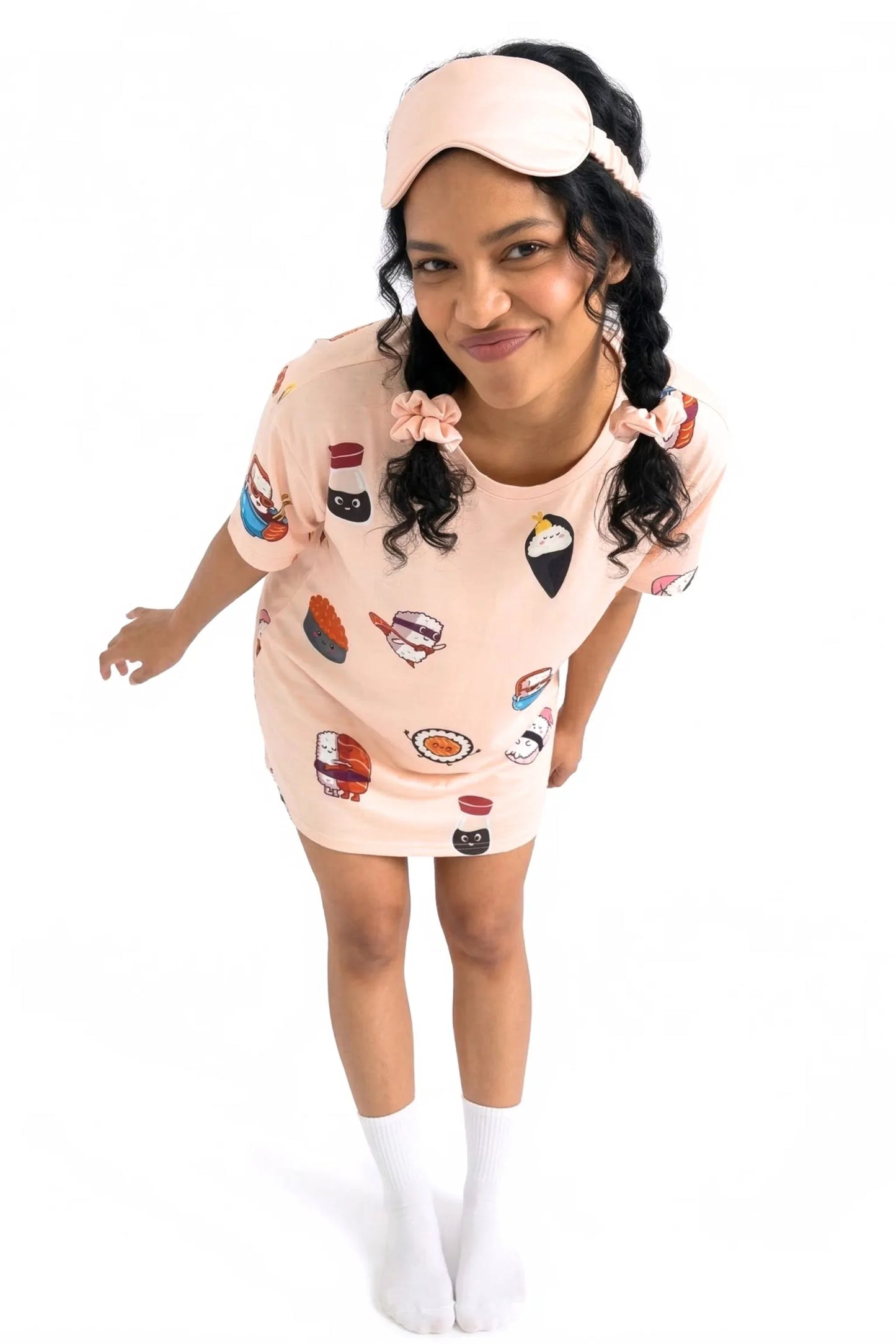 Woman wearing full Soy Cozy bamboo accessory set with scrunchies in pigtails sleep mask and sushi print sleep tee