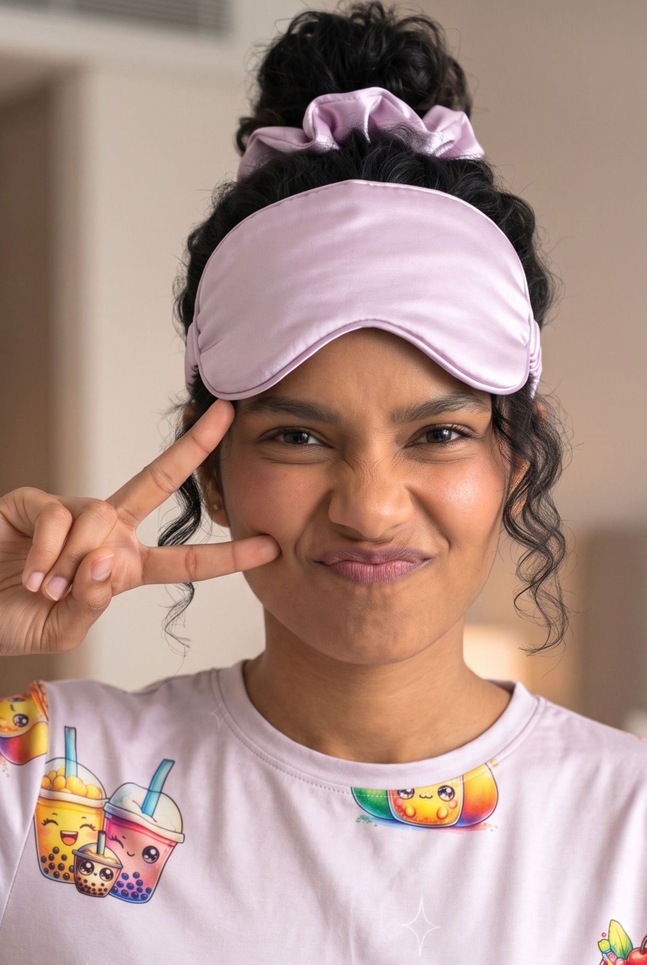 Woman in The Bubble Tee bubble tea print sleep tee wearing a lilac sleep mask and scrunchie