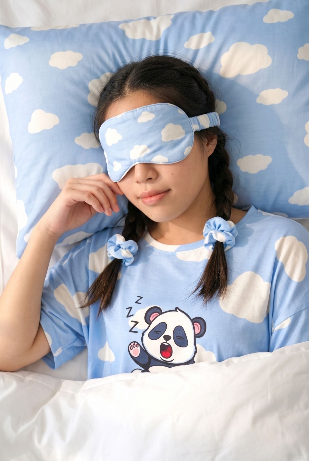 Woman resting with Un-bear-ably Sleepy bamboo sleep mask and scrunchies in blue cloud print