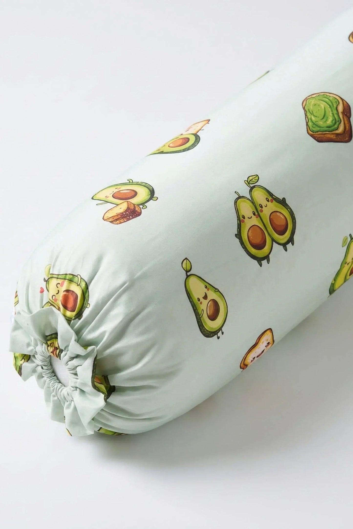 A close-up detail shot of the mint green ruffled drawstring closure on the Avo-Good Night avocado and toast bolster cover.