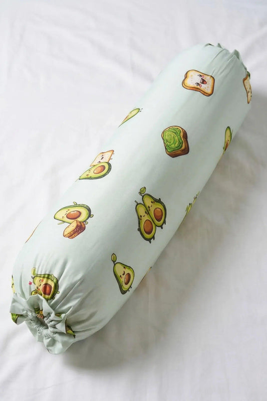 A full-length, top-down view of the Avo-Good Night bolster cover featuring a cute avocado and toast pattern on a mint green background.