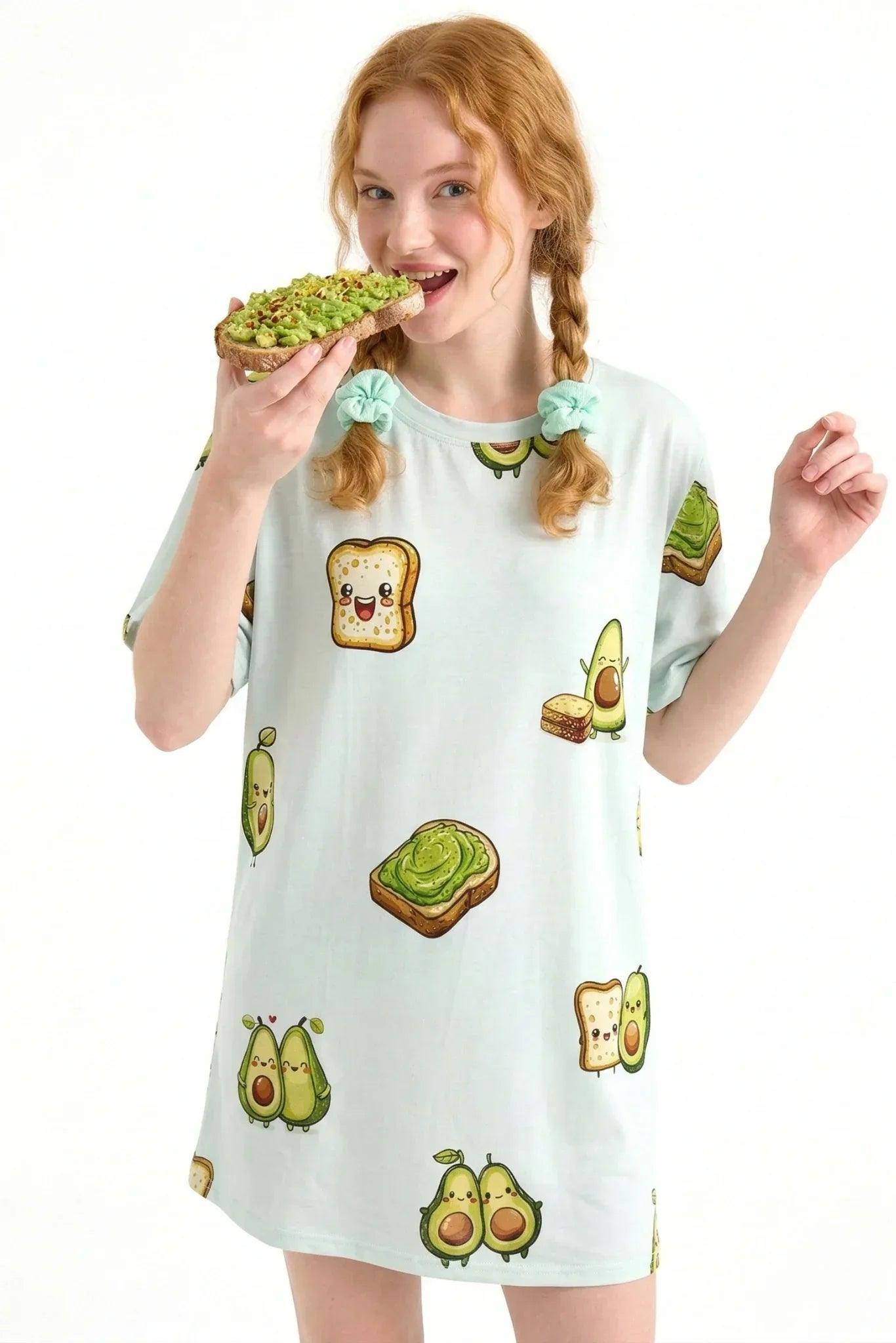 Woman eating avocado toast while lounging in the breathable, cooling bamboo Avo-Good Night sleep tee in petite sizing.