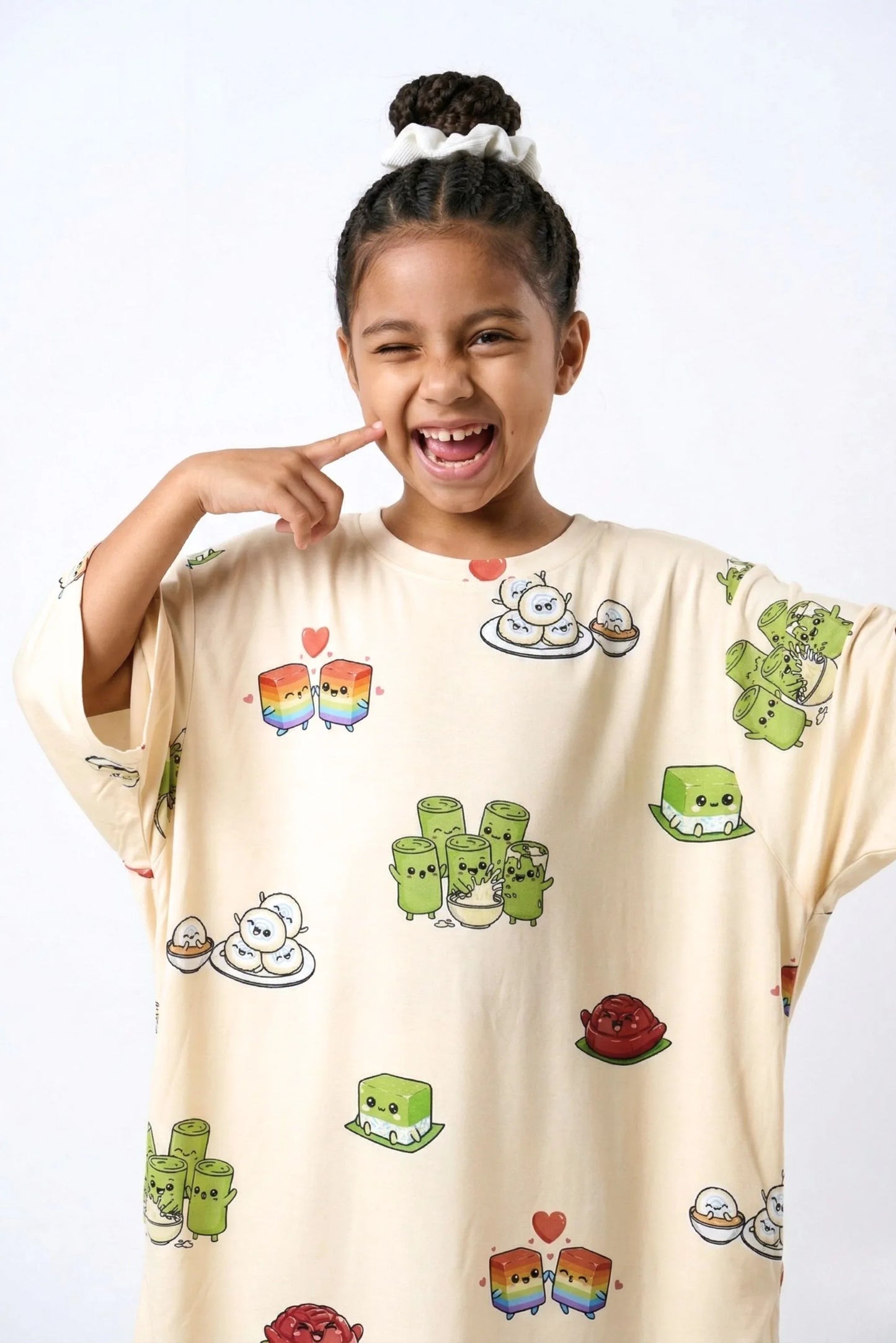 Close-up of child wearing Kueh-zy Medley kids bamboo sleep tee with kawaii kueh lapis and ondeh ondeh characters