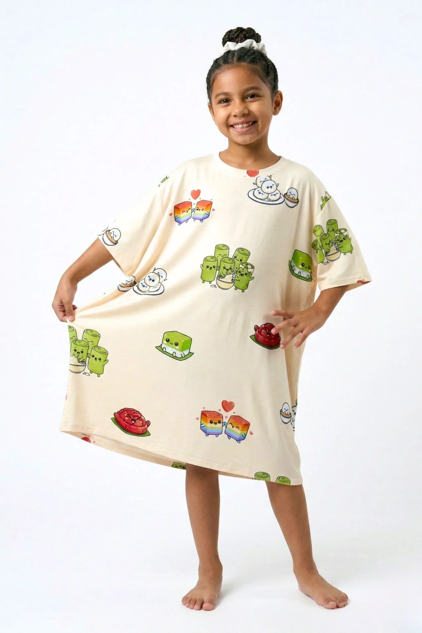 Child holding hem of Kueh-zy Medley kids oversized bamboo sleep tee showing full width and kueh print