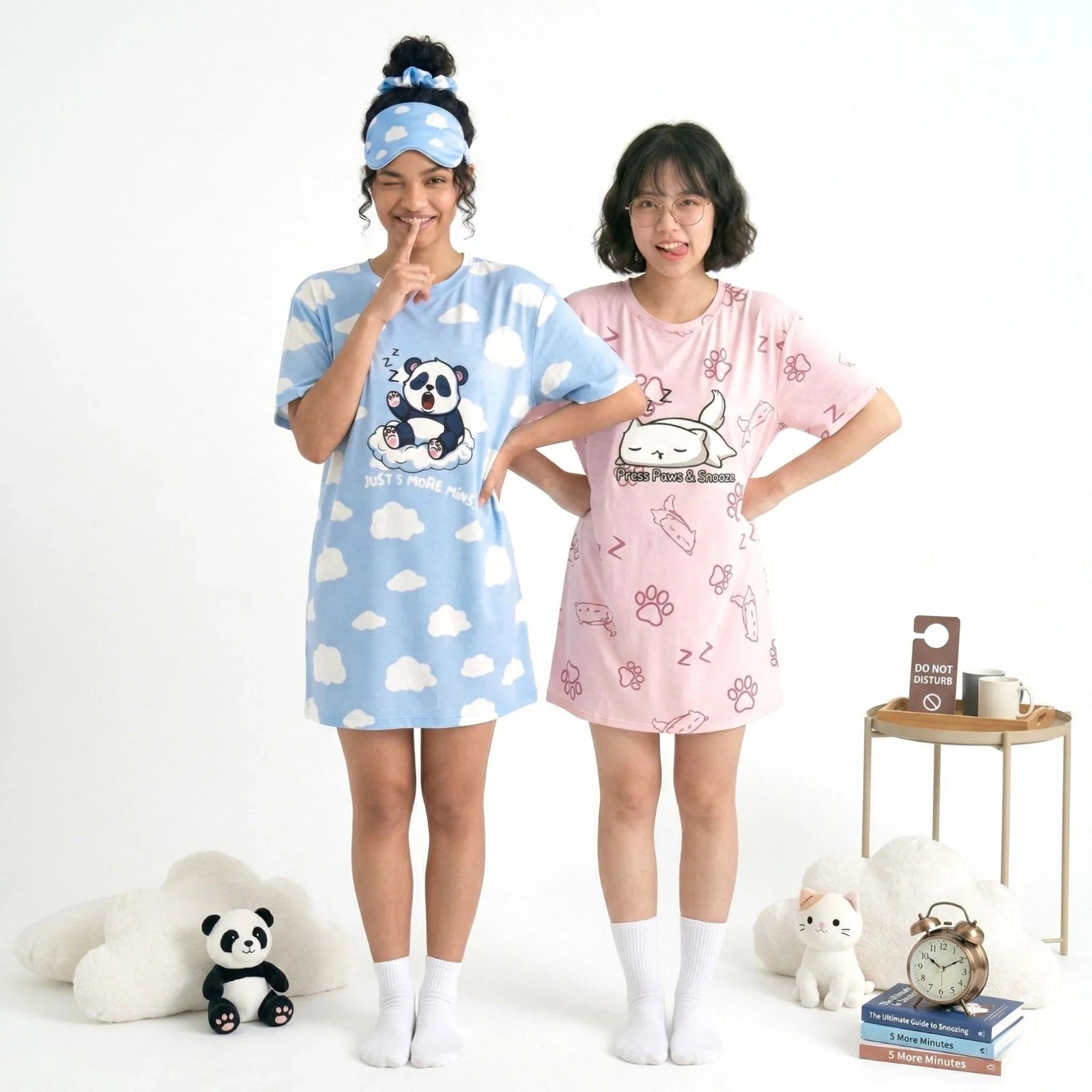 Two women wearing cartoon-themed bamboo sleep tees with panda and cat designs from the petite collection, standing in a room with a small table and decor items. 