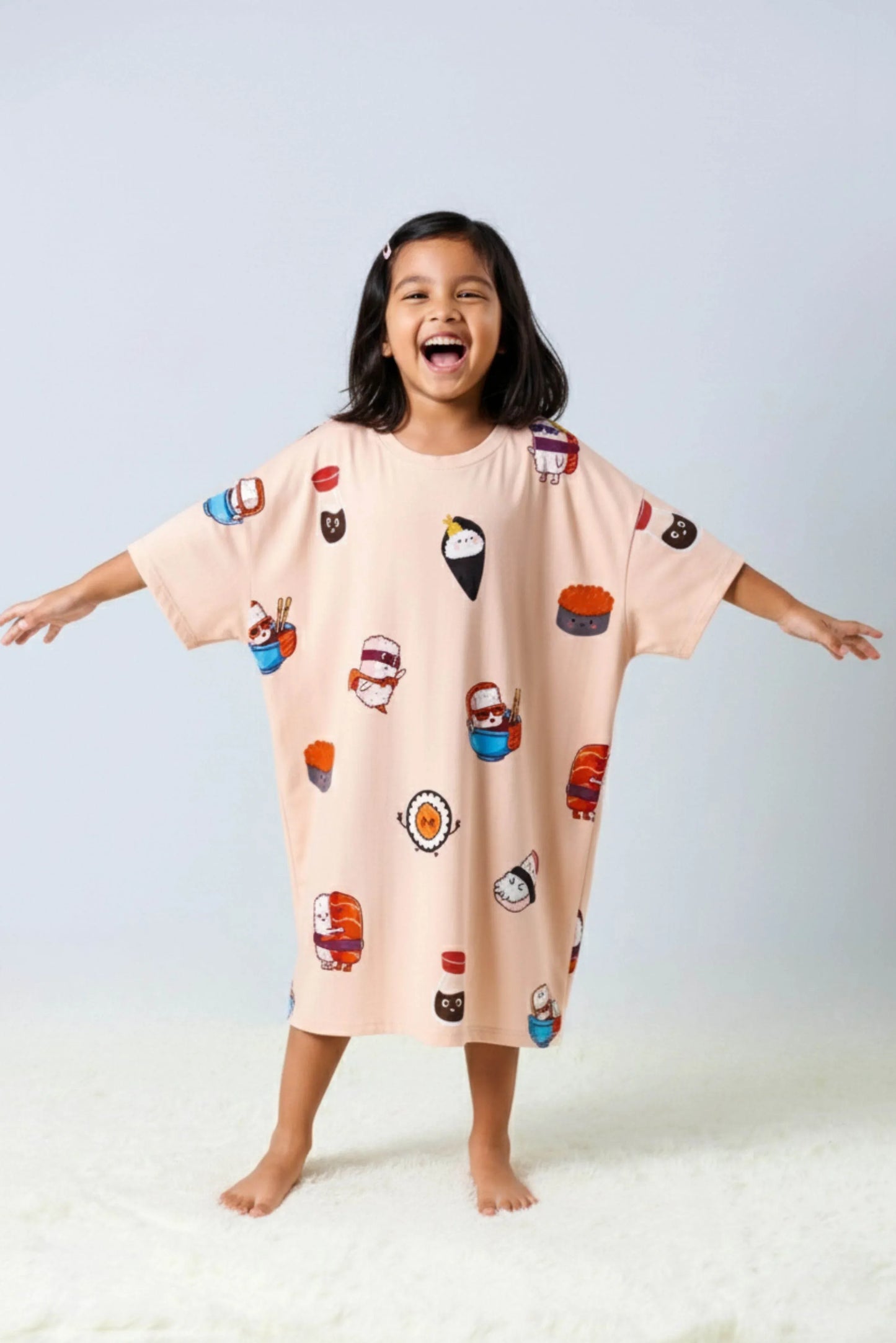 Child wearing oversized Bamboo Loungewear with cartoon character prints on a light gray background