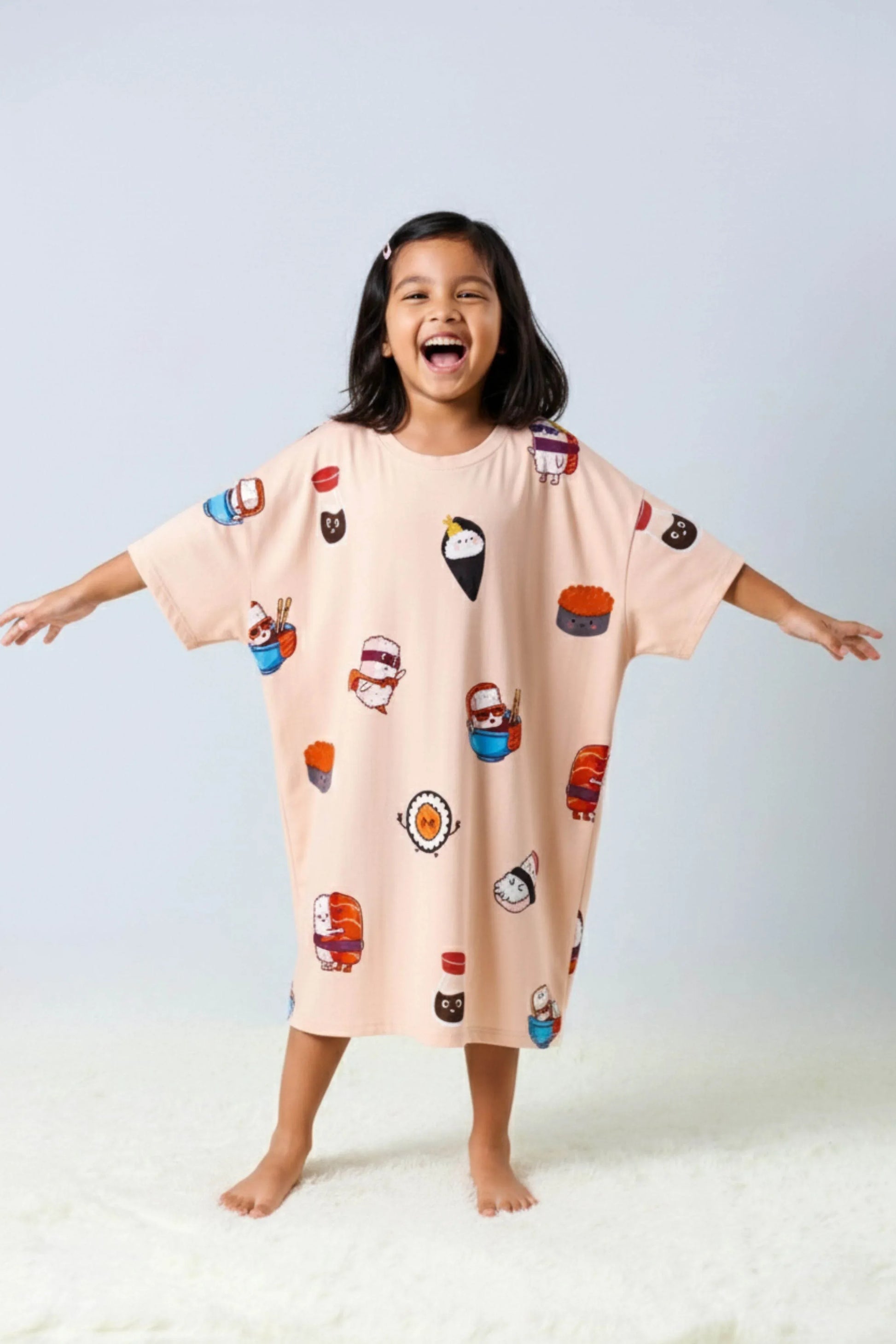 Child wearing oversized Bamboo Loungewear with cartoon character prints on a light gray background