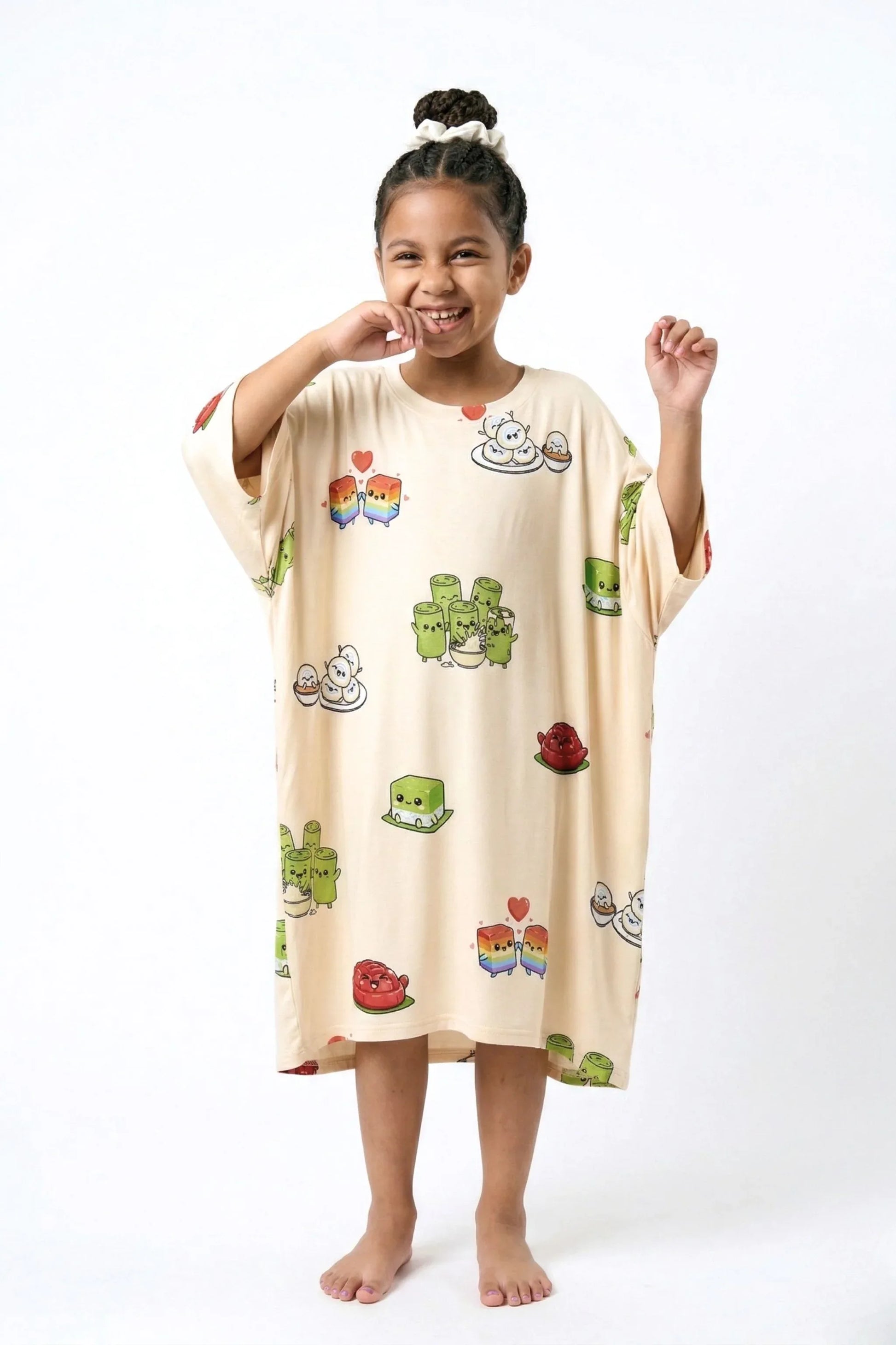Child wearing Kueh-zy Medley kids oversized bamboo sleep tee with kawaii kueh print