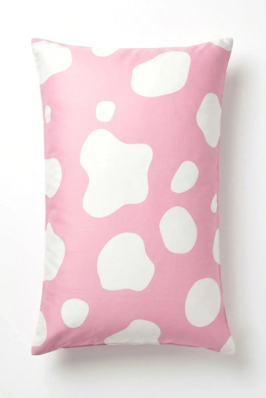 Pink and white cow print bamboo pillow case on white background