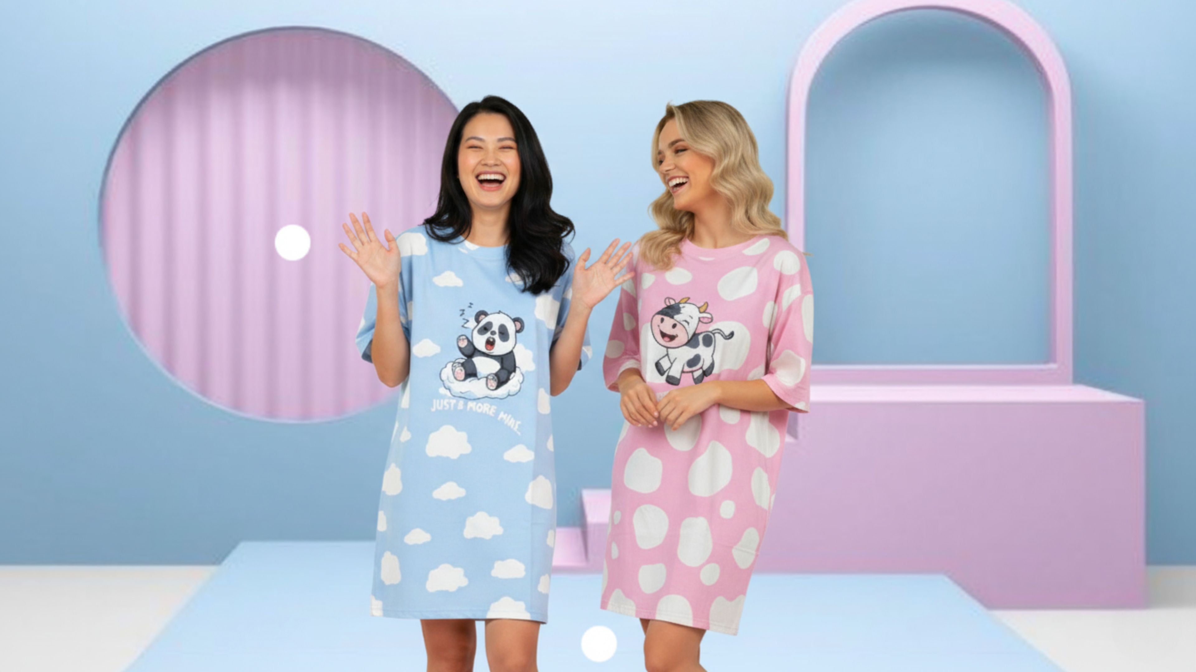 Two women wearing oversized bamboo sleepwear from the petite collection by MySleepTee with cartoon characters in a colorful room.