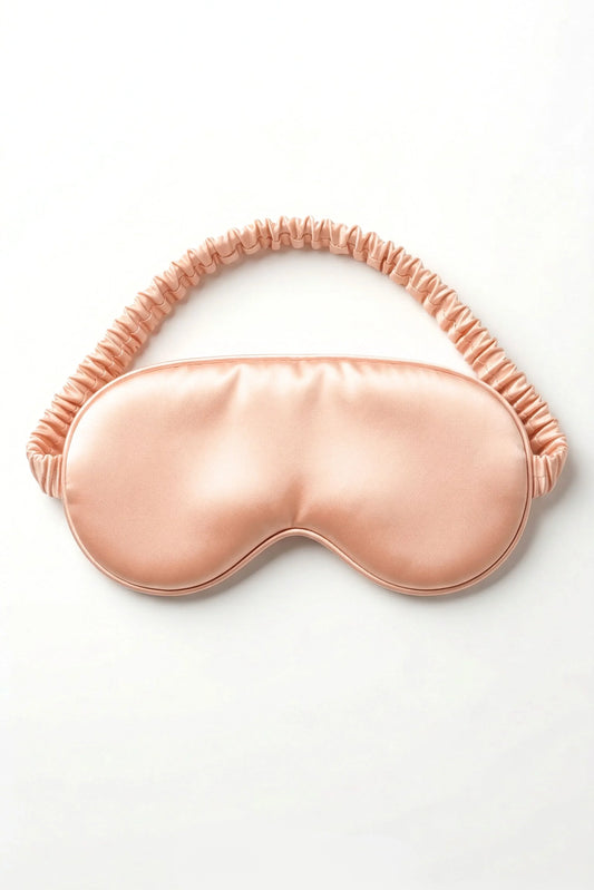 Salmon pink bamboo sleep mask with elastic strap on white background