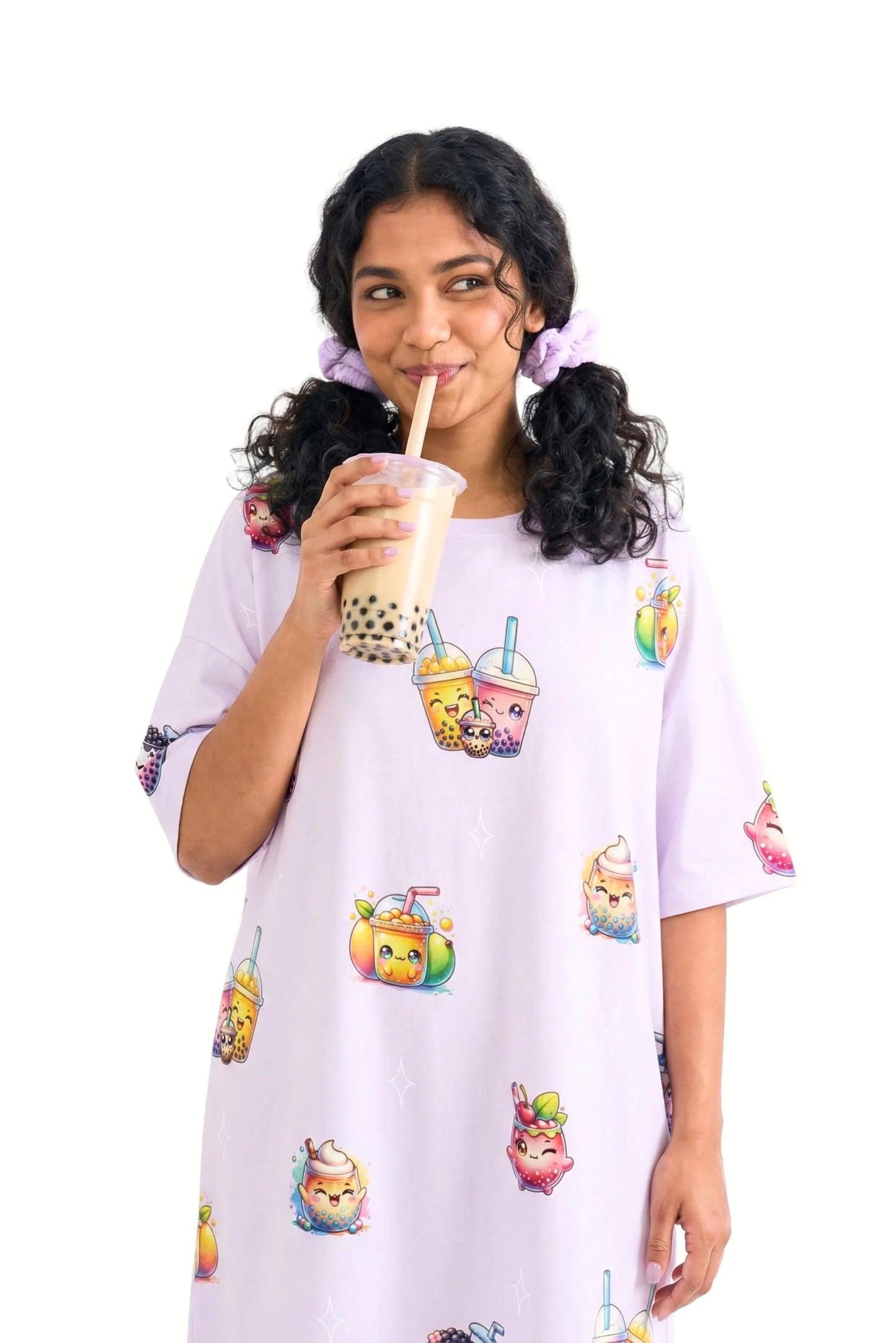 Woman wearing a purple oversized bamboo sleep tee with colorful boba tea graphics, holding a drink.