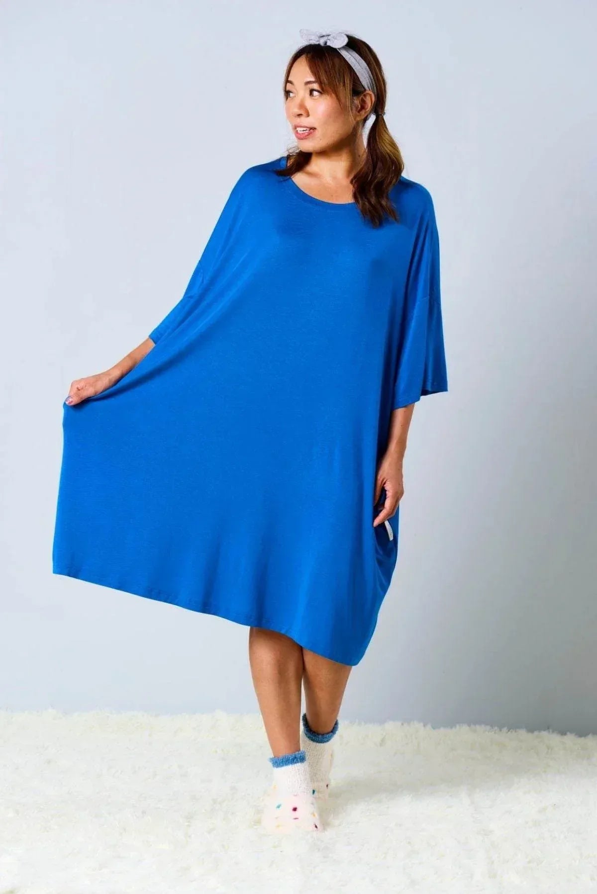 Woman wearing a oversized, ocean blue, bamboo sleep tee by MySleepTee