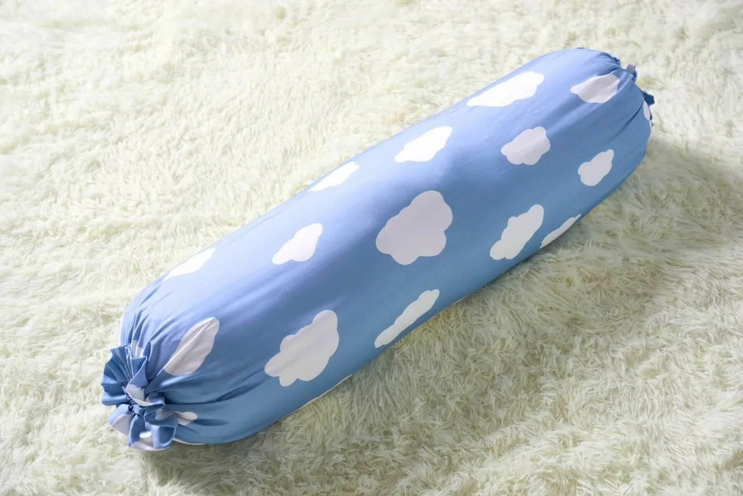 Blue bolster with white cloud patterns