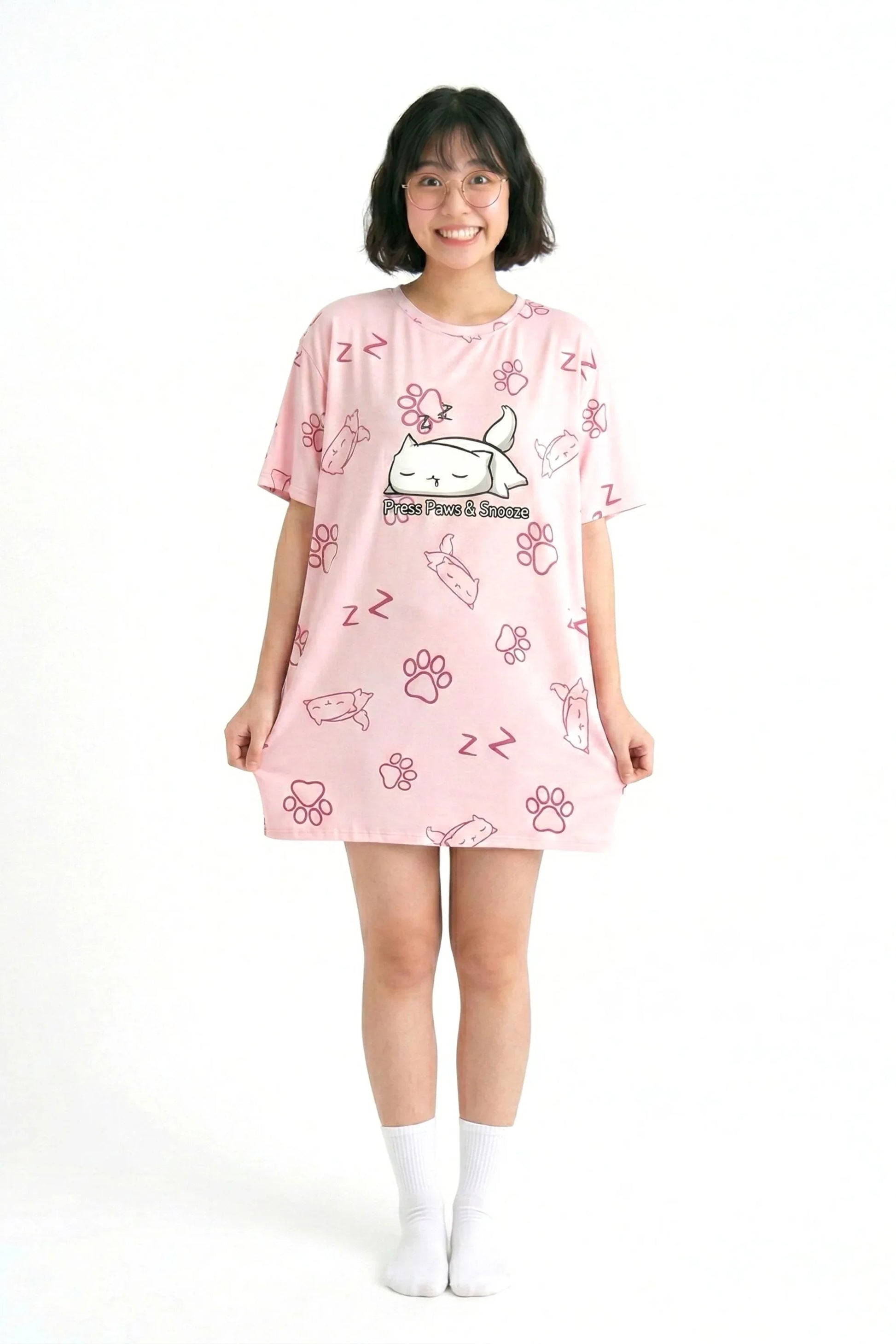 Full-length view of the MySleepTee petite oversized bamboo sleep tee in pink, showing the shorter length tailored for petite frames. The model is wearing white crew socks.