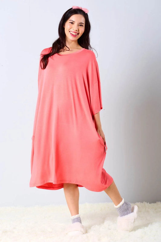 Woman wearing a red oversized bamboo sleep tee by MySleepTee