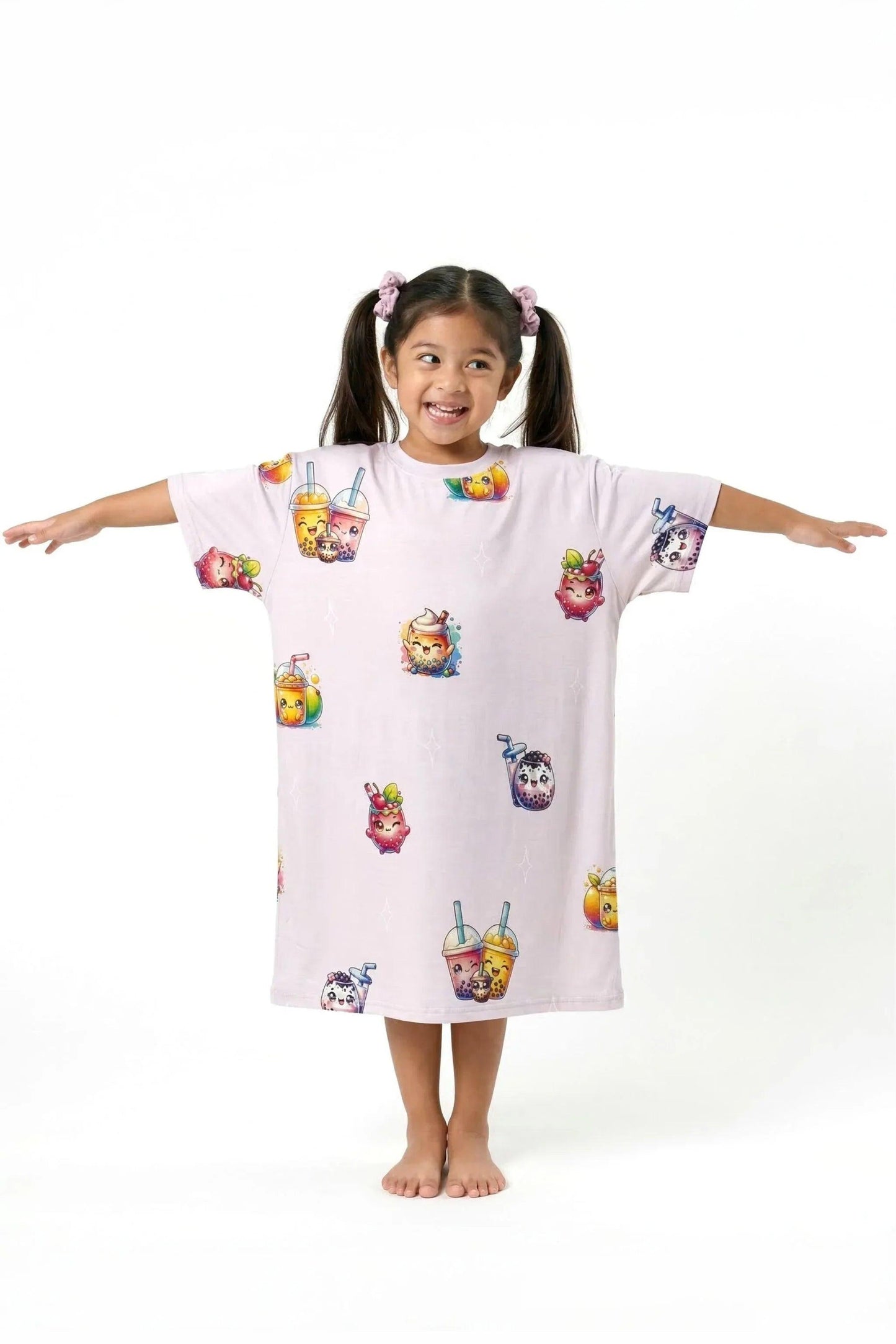 A happy young girl standing barefoot with her arms stretched out wide, showing off the relaxed, comfortable fit of the MySleepTee™ The Bubble Tee | Kids from the Kids - Mini Me collection.