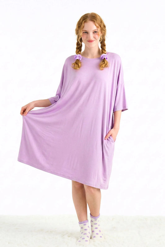 Woman wearing a purple bamboo sleep tee from MySleepTee on a white background