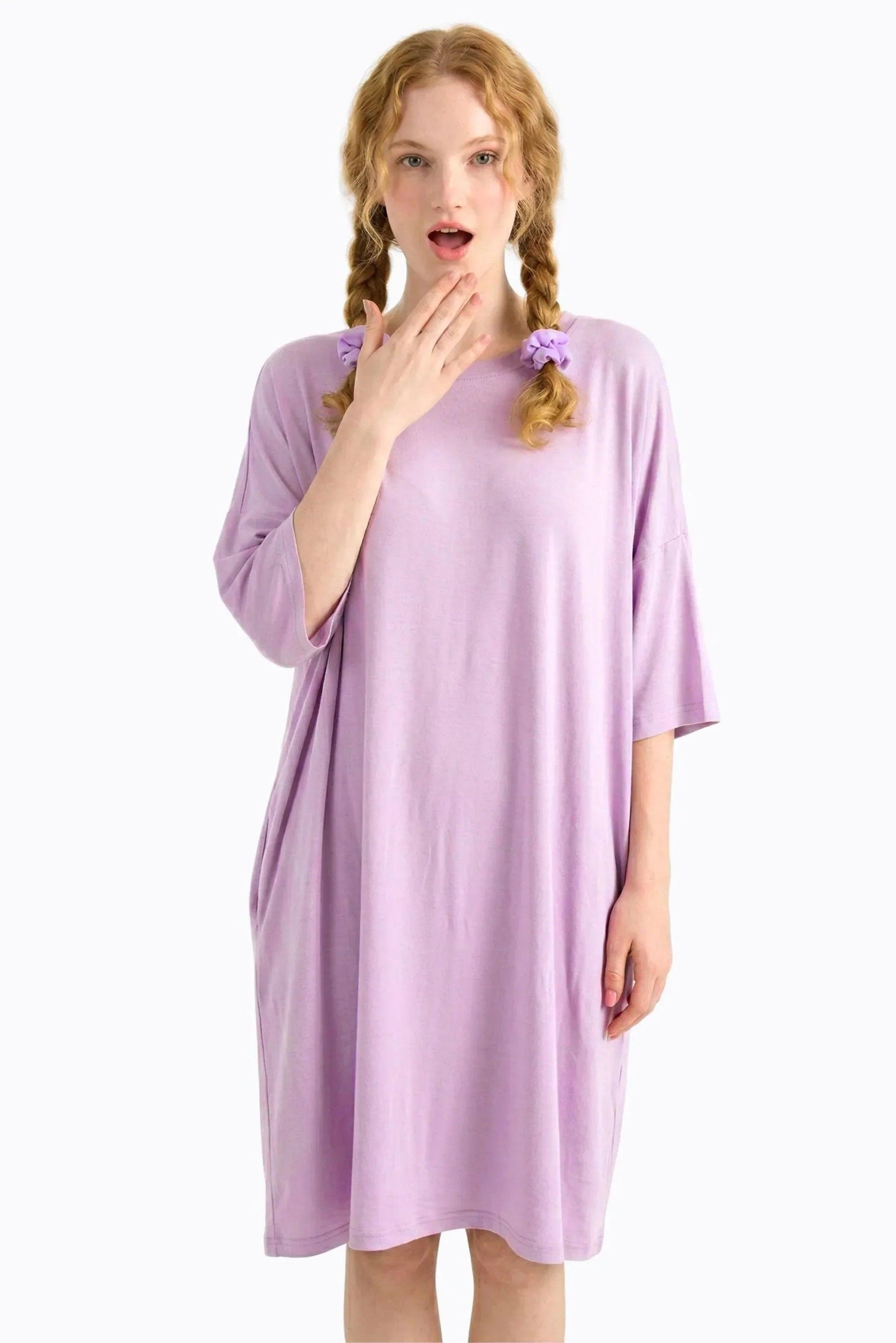 Woman wearing a purple nightgown on a white background