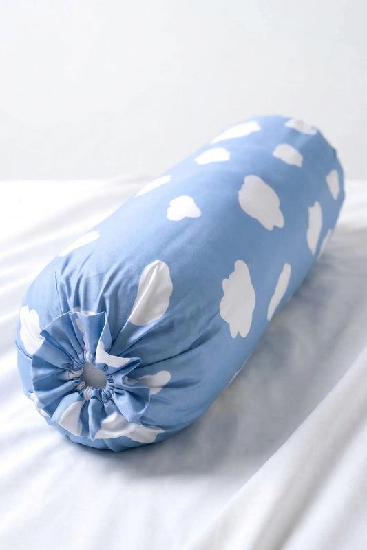 A detailed close-up showing the neatly gathered, ruffled closure on the end of the MySleepTee Un-bear-ably Sleepy bamboo bolster cover. The fabric features a sweet light blue with white cloud print, resting softly on crisp white bedding. Ideal cooling sleep accessory.