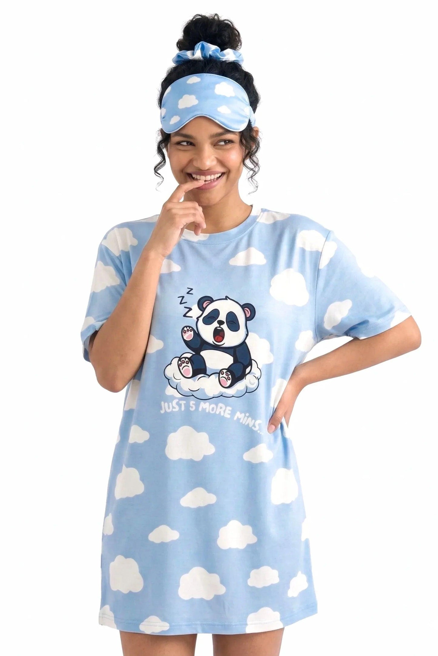 Woman smiling playfully wearing the Un-bear-ably Sleepy Petite light blue cloud print sleep tee and matching sleep mask from MySleepTee.