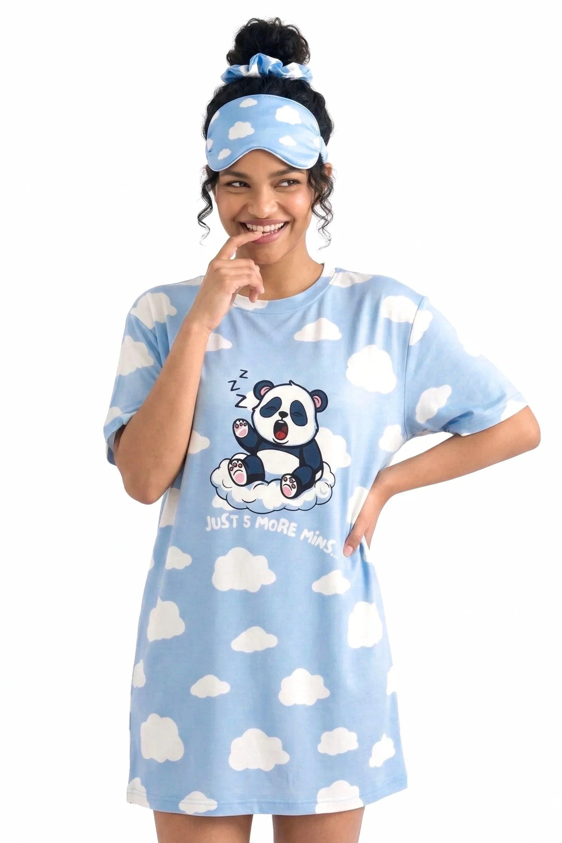 Woman smiling playfully wearing the Un-bear-ably Sleepy Petite light blue cloud print sleep tee and matching sleep mask from MySleepTee.