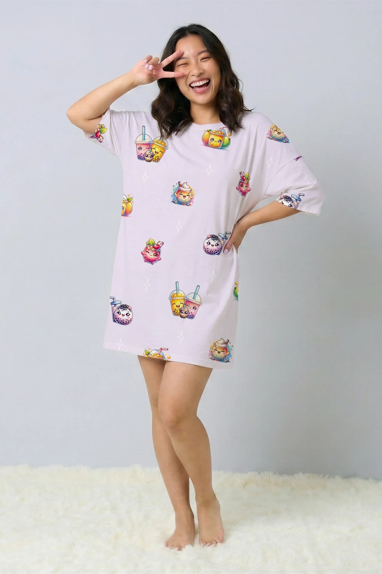 Woman laughing and making a peace sign over her eye while wearing a purple oversized bamboo sleep tee. Fun and comfortable sleepwear with a kawaii bubble tea print, designed for Singapore nights.