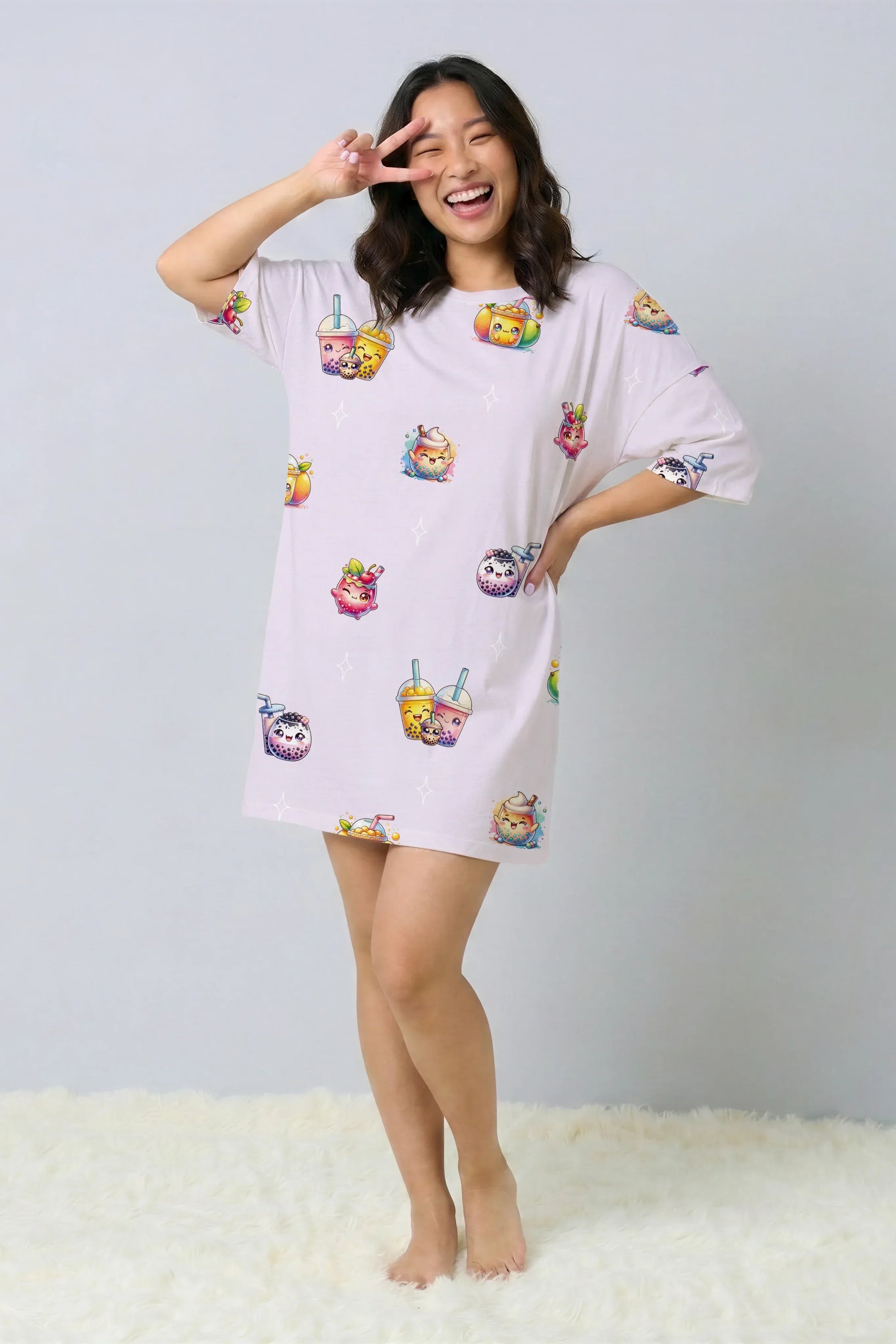 Woman laughing and making a peace sign over her eye while wearing a purple oversized bamboo sleep tee. Fun and comfortable sleepwear with a kawaii bubble tea print, designed for Singapore nights.
