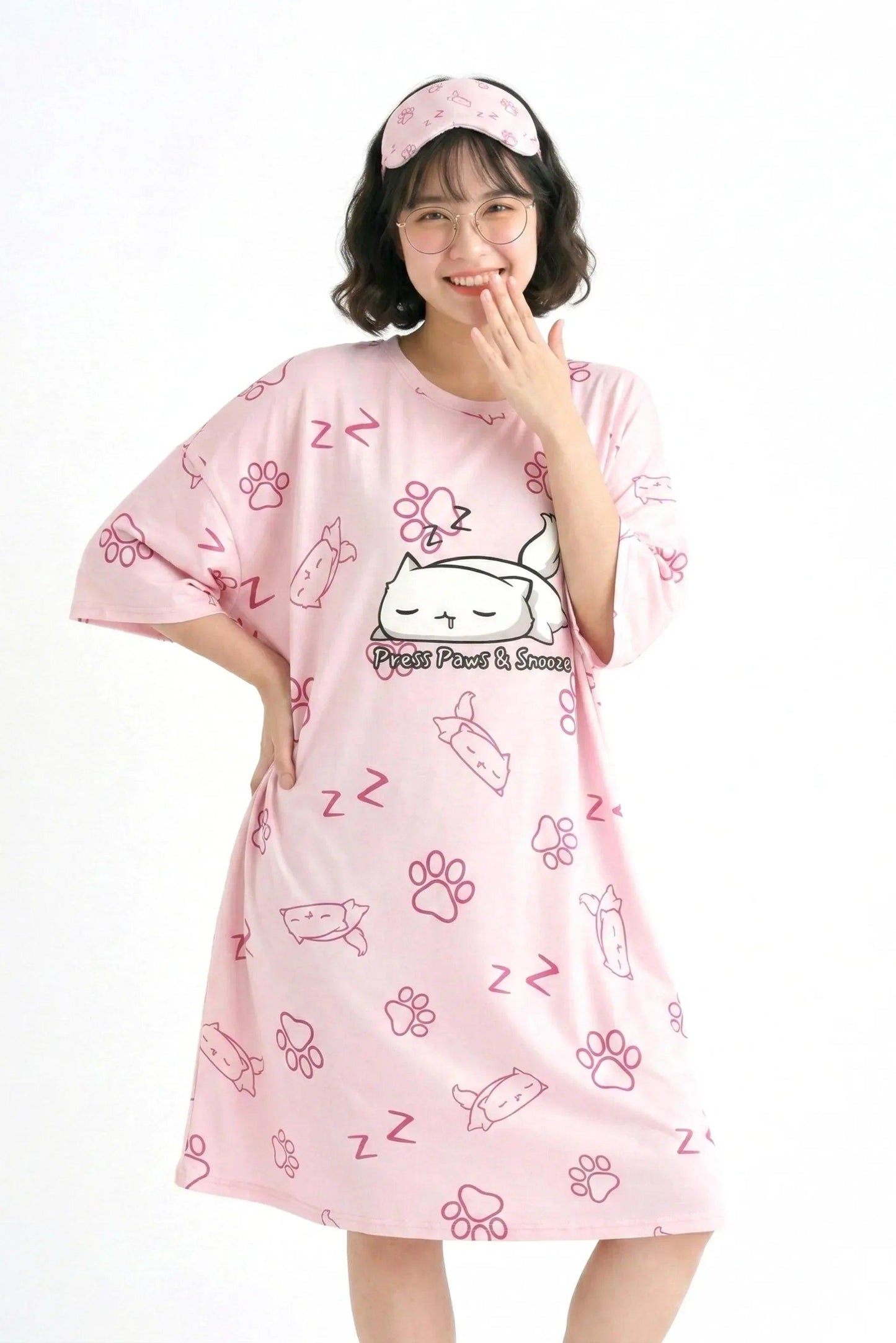 Model showcasing the loose, oversized fit of the MySleepTee bamboo sleep dress in pink with an all-over cat paw and "Z" print.
