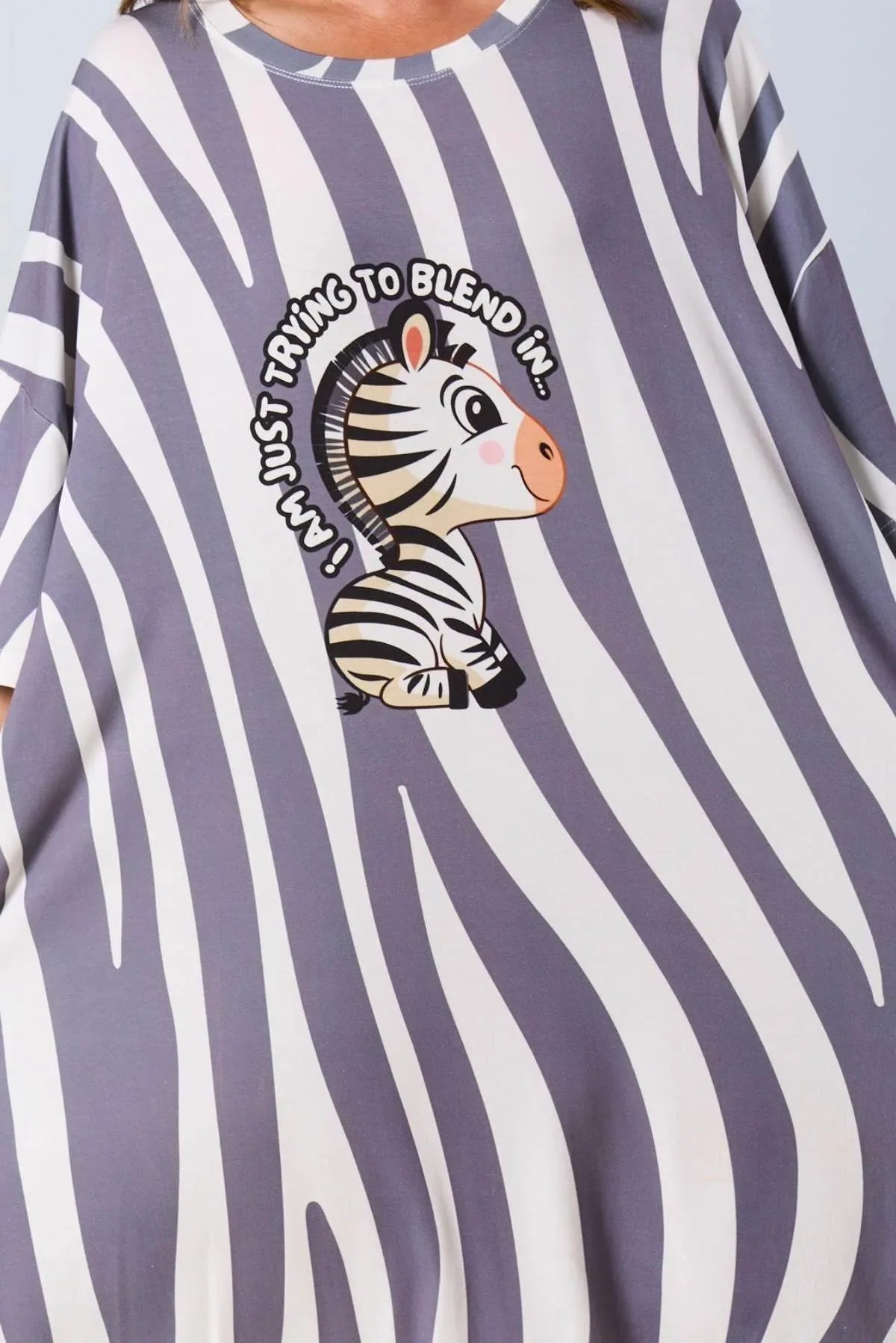 Zebra-themed shirt with a zebra graphic and text on a striped background
