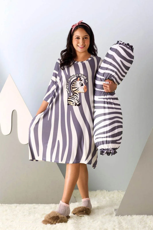 Woman wearing a zebra-themed sleep tee by MySleepTee and holding a matching bolster cover against a light gray background