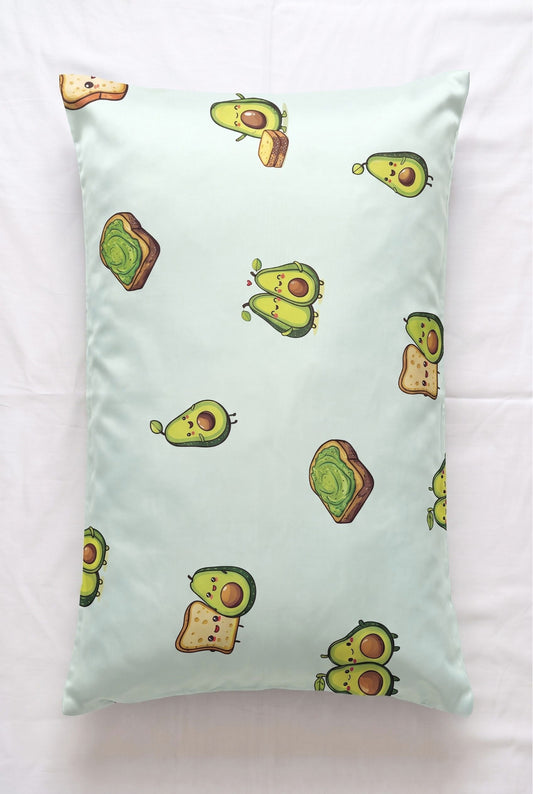 Avo-Good Night bamboo pillowcase in mint avocado toast print, flat lay on white