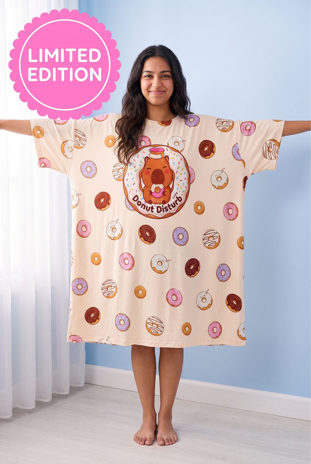 Front view of the Donut Disturb Original oversized bamboo sleep tee with arms outstretched, showing the wide dropped-shoulder sleeves and knee-length hem.