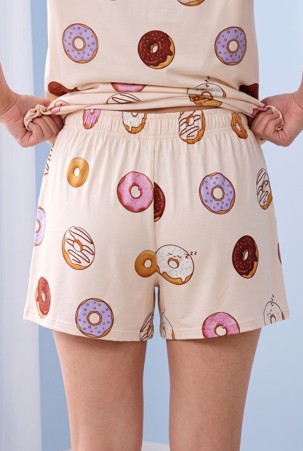 Close view of the Donut Disturb bamboo shorts from the back with the tee lifted, showing the soft gathered elasticated waistband and the loose relaxed fit through the hip.