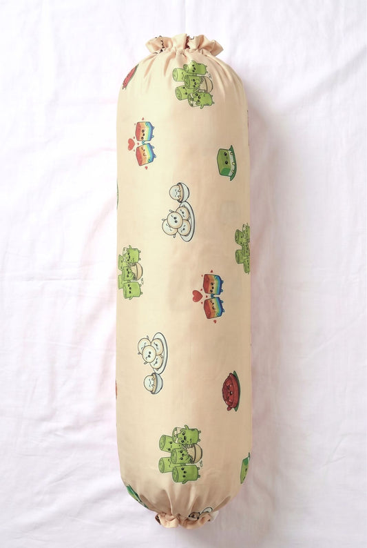Kueh-zy Medley bamboo bolster cover in cream kueh print, flat lay on a white bed