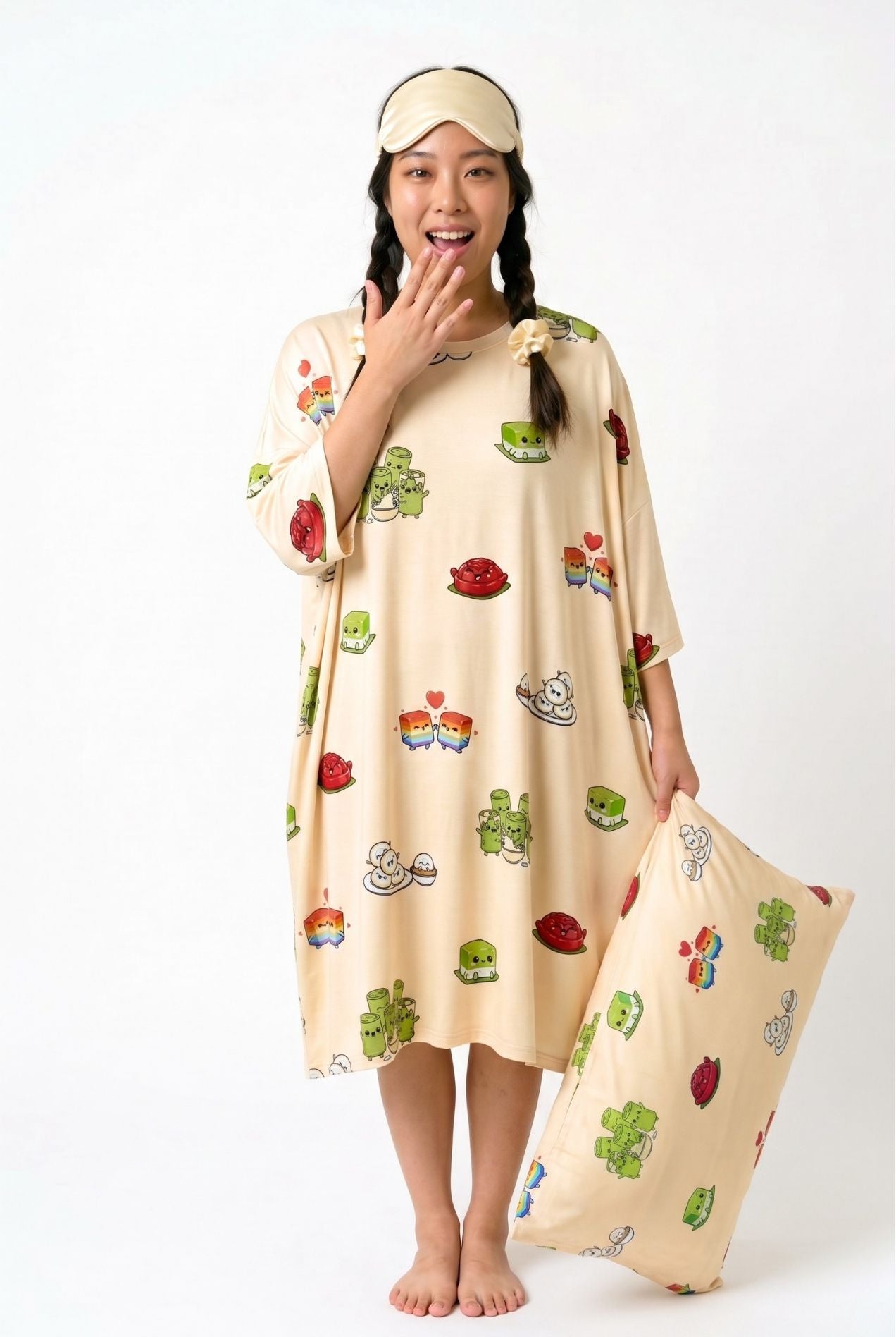 Woman in Kueh-zy Medley cream kueh print sleep tee holding a matching bamboo pillow