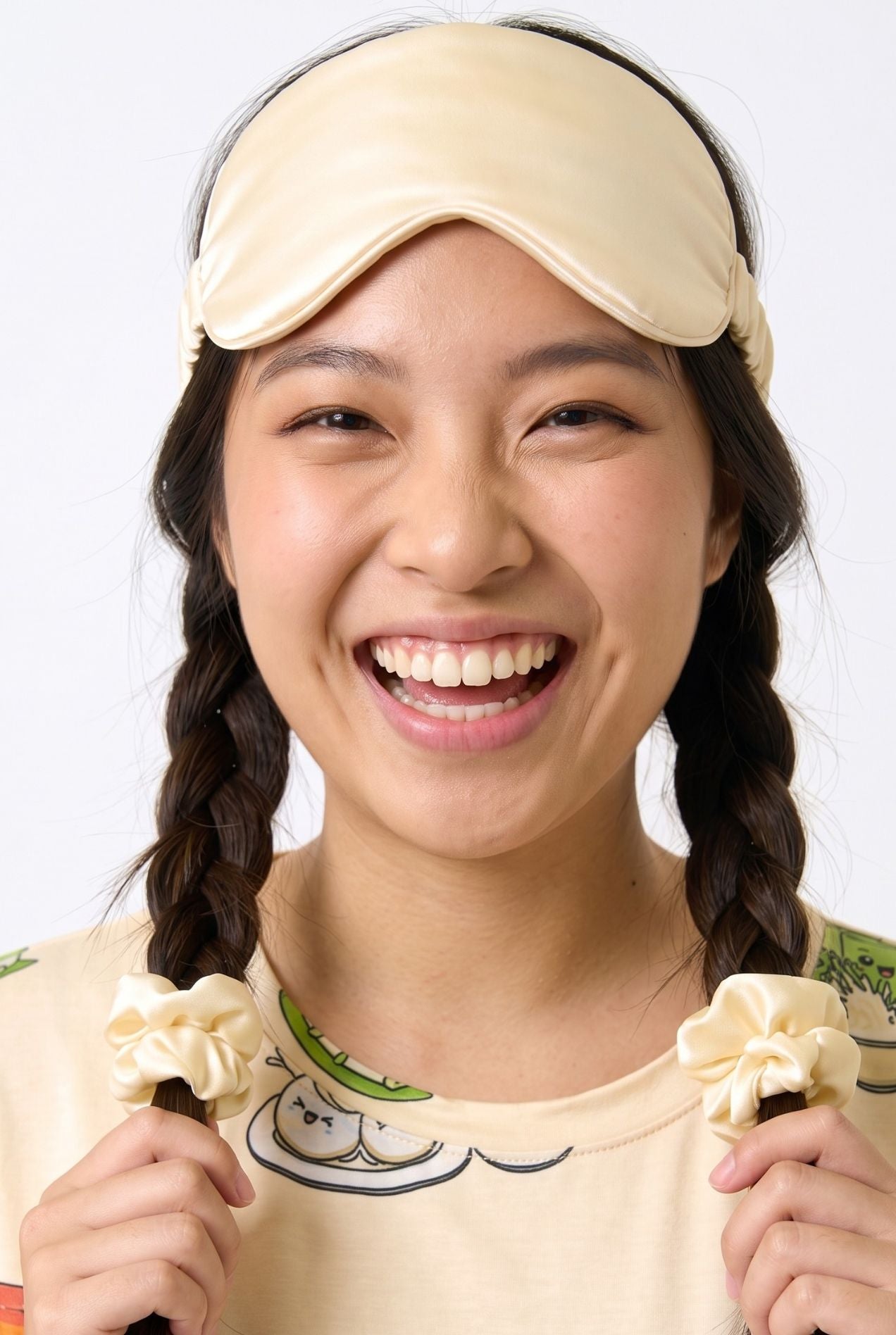 Woman wearing cream Kueh-zy Medley scrunchies in pigtails with matching kueh print sleep tee