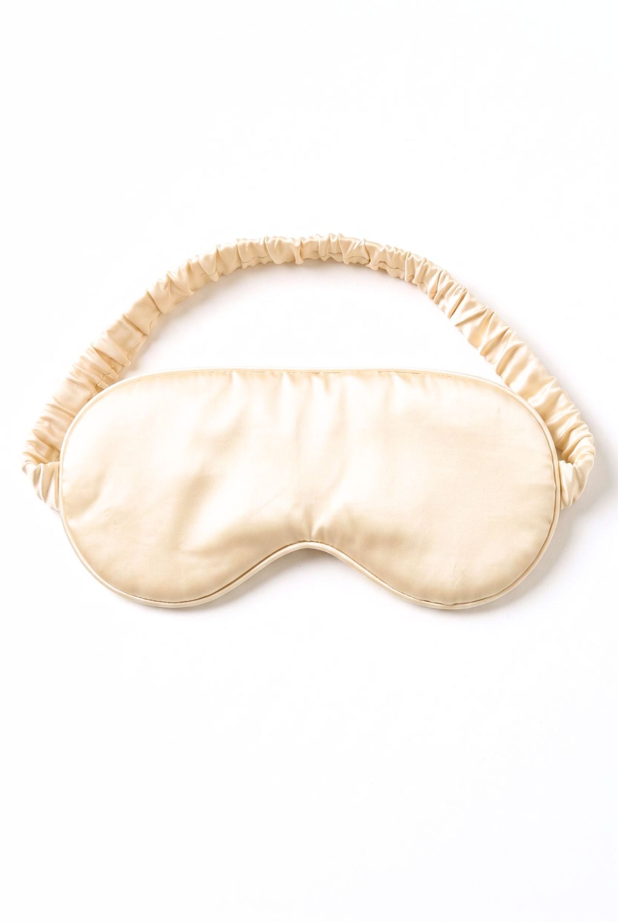Kueh-zy Medley sleep mask in solid cream with elastic band, flat lay on white