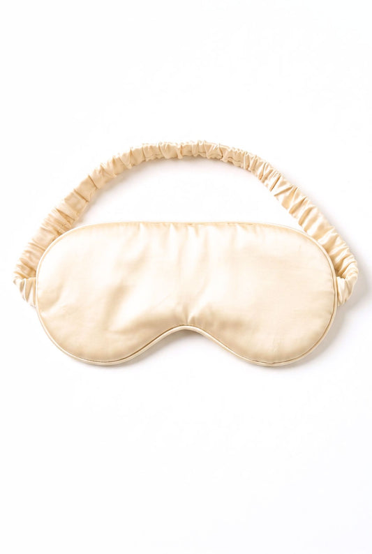 Kueh-zy Medley sleep mask in solid cream with elastic band, flat lay on white