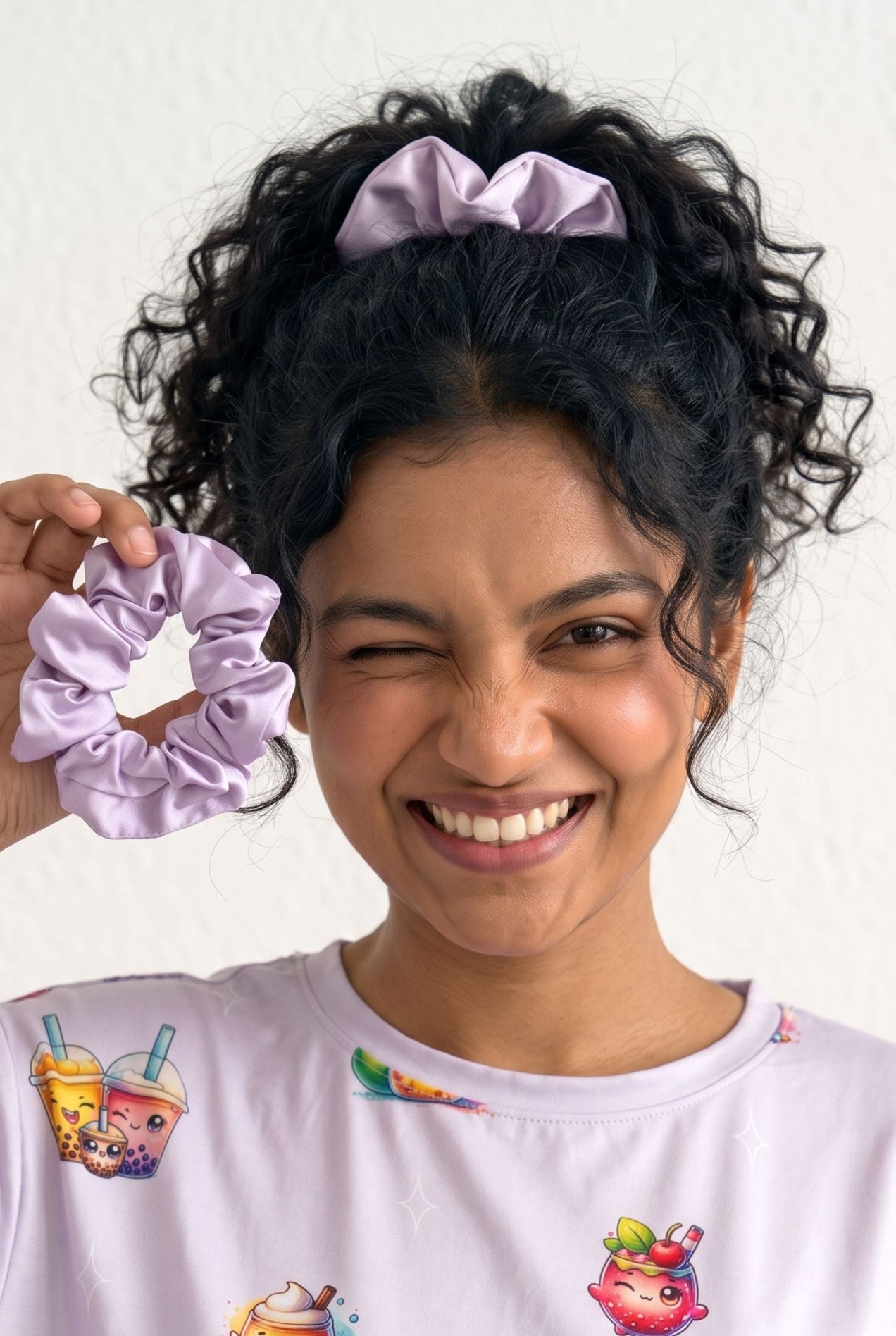 Close-up of a lilac The Bubble Tee bamboo scrunchie held in hand with matching bubble tea print sleep tee