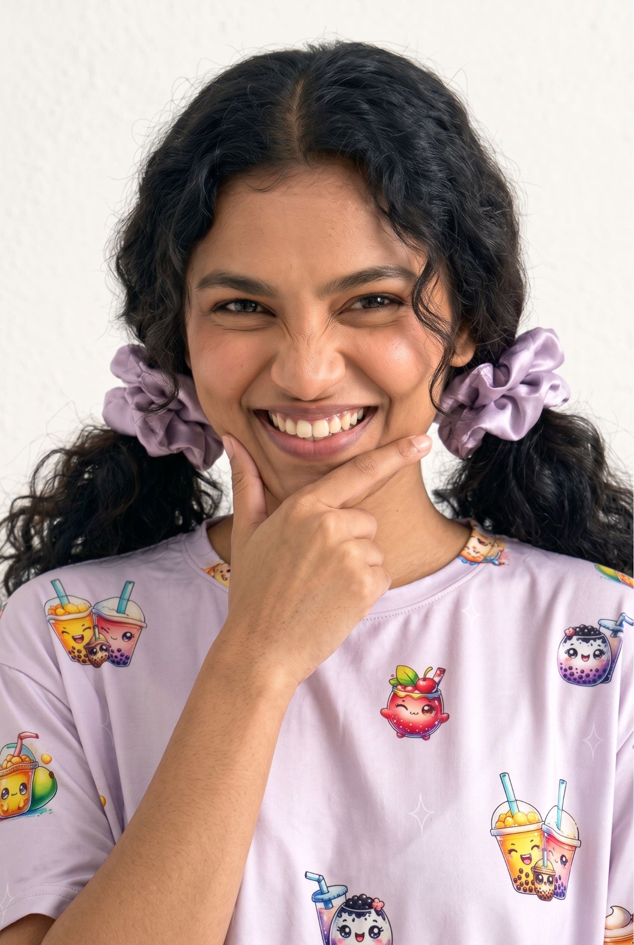 Woman wearing The Bubble Tee lilac bamboo scrunchies in pigtails with matching bubble tea print sleep tee