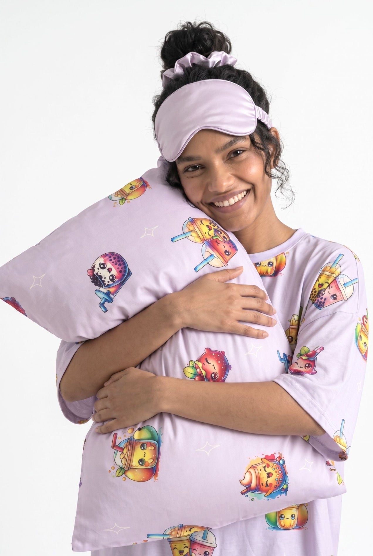 Woman in The Bubble Tee lilac bubble tea print sleep tee hugging a matching bamboo pillow