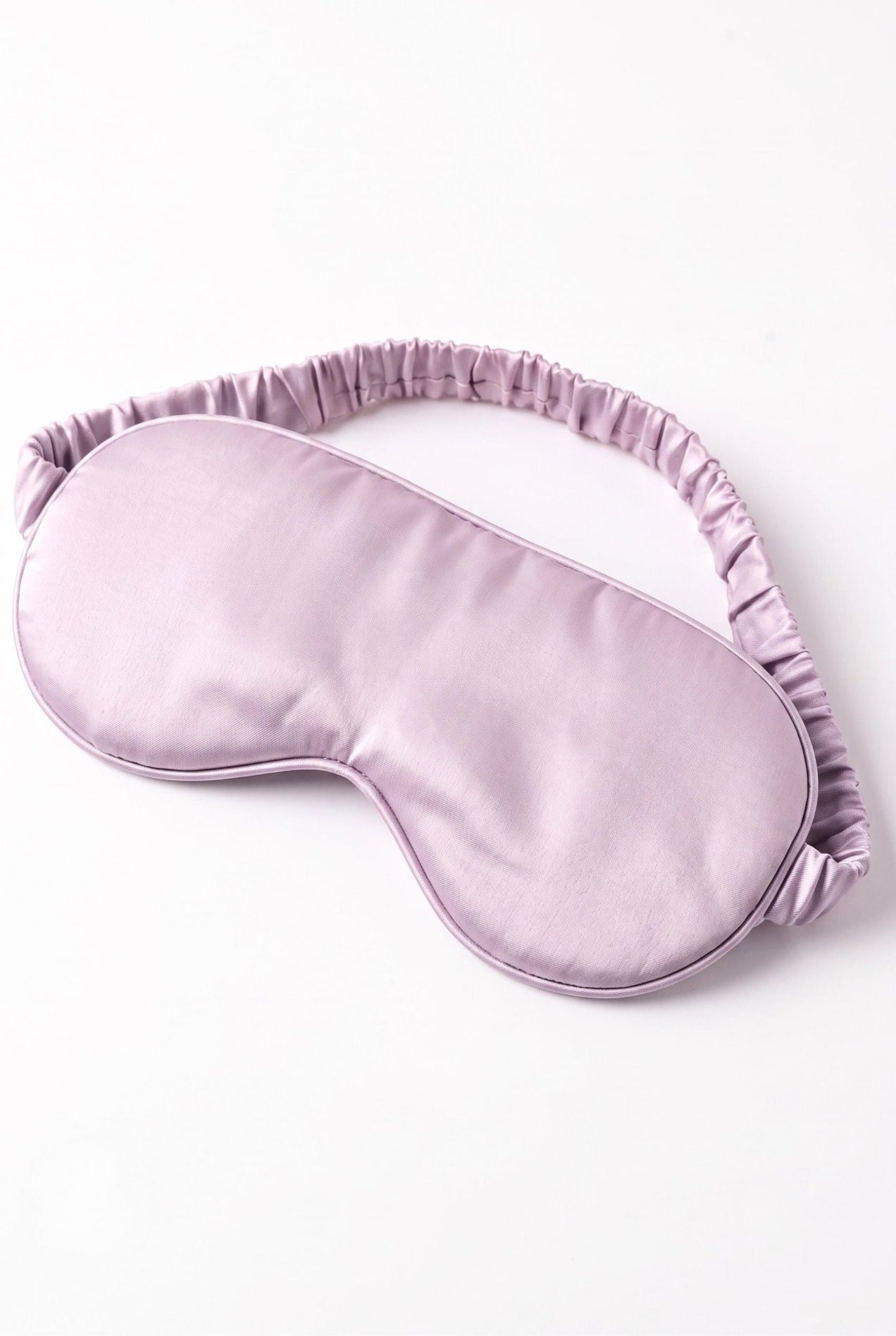 The Bubble Tee sleep mask in solid lilac with elastic band, flat lay on white
