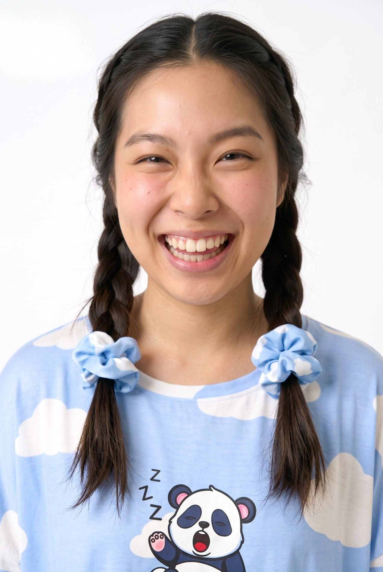 Woman wearing Un-bear-ably Sleepy bamboo scrunchies in blue cloud print tied in pigtails