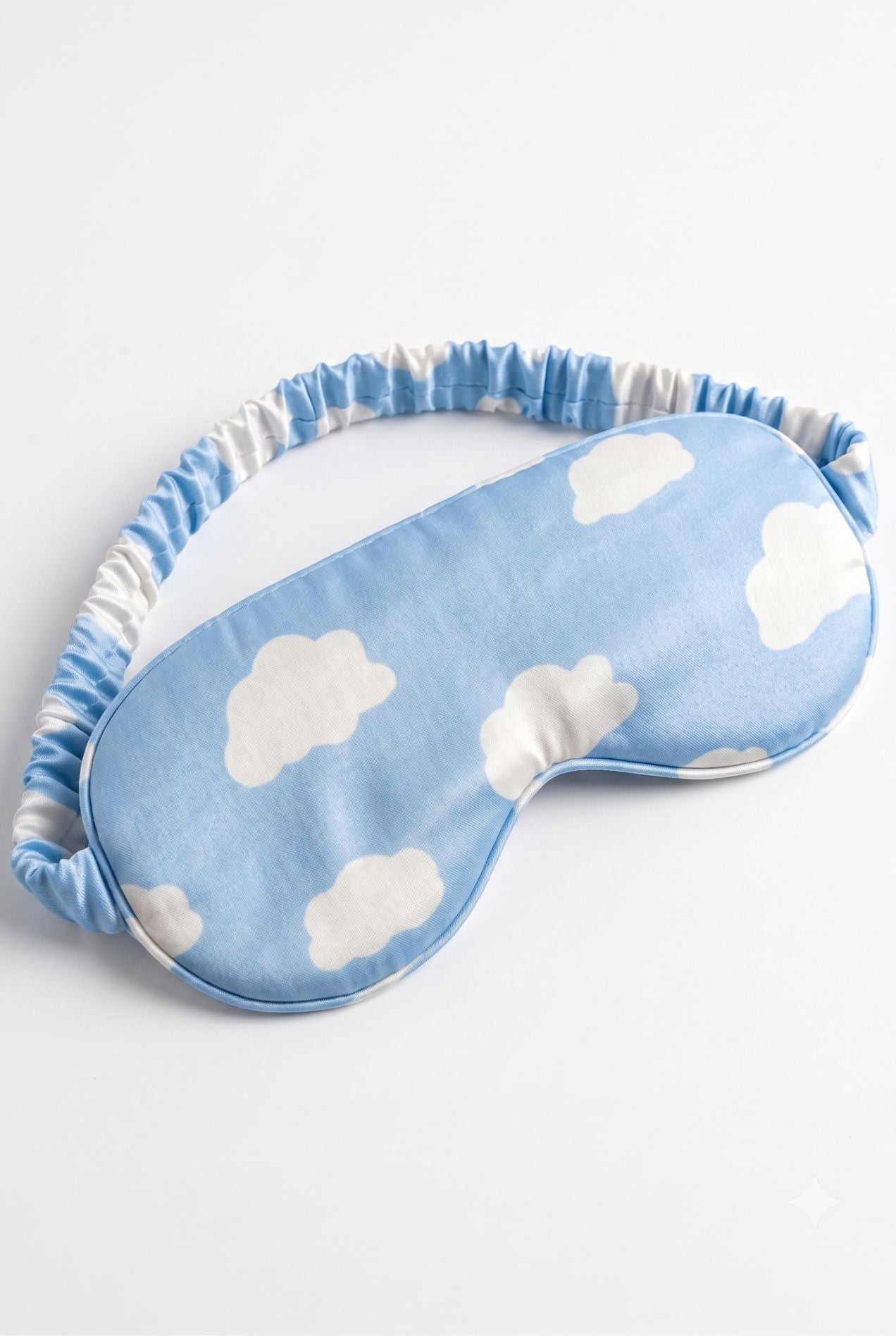 Un-bear-ably Sleepy bamboo sleep mask in blue cloud print, flat lay on white