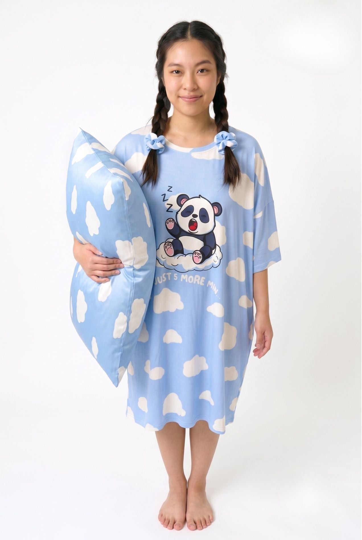 Woman in Un-bear-ably Sleepy cloud-print sleep tee holding a matching bamboo pillowcase
