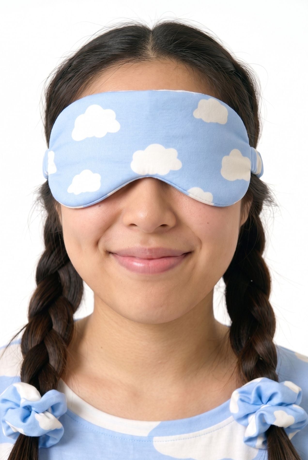 Woman wearing Un-bear-ably Sleepy bamboo sleep mask in blue cloud print, eyes closed